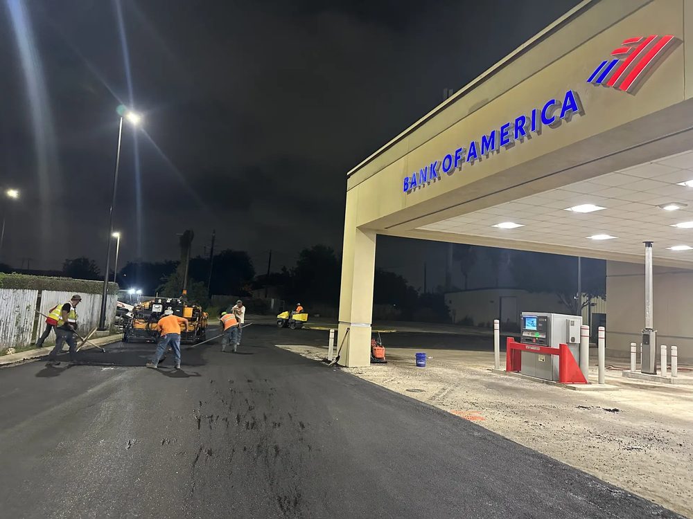A Lonestar Construction Industries crew paving a commercial lot at night in the San Antonio area